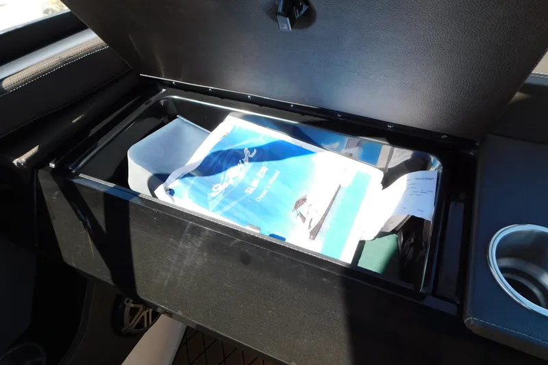 Slide: The Image of Open storage compartment with Sea Ray SLX-W 230 manual, 2018 model. - 47
