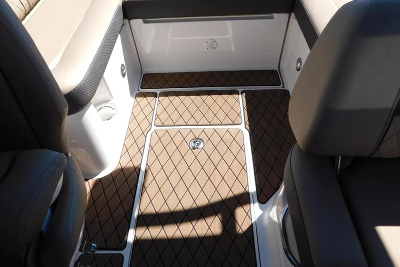 Slide: The Image of 2018 Sea Ray SLX-W 230 interior with diamond-patterned flooring and cushioned seating. - 49