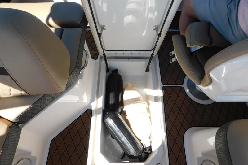 Slide: The Image of Storage compartment on 2018 Sea Ray SLX-W 230 boat with life jackets and equipment. - 50