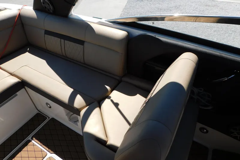 Slide: The Image of 2018 Sea Ray SLX-W 230 boat interior with beige leather seating and stylish design. - 51