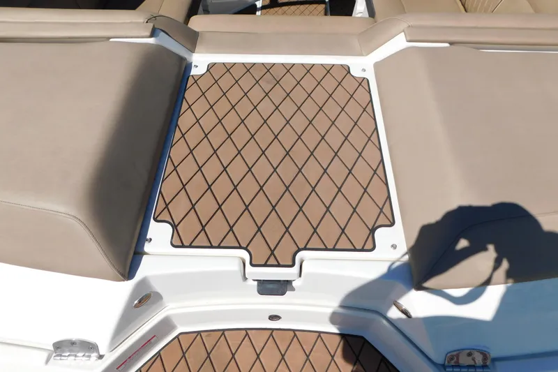 Slide: The Image of 2018 Sea Ray SLX-W 230 boat deck with tan cushioned seating and diamond-patterned flooring. - 56