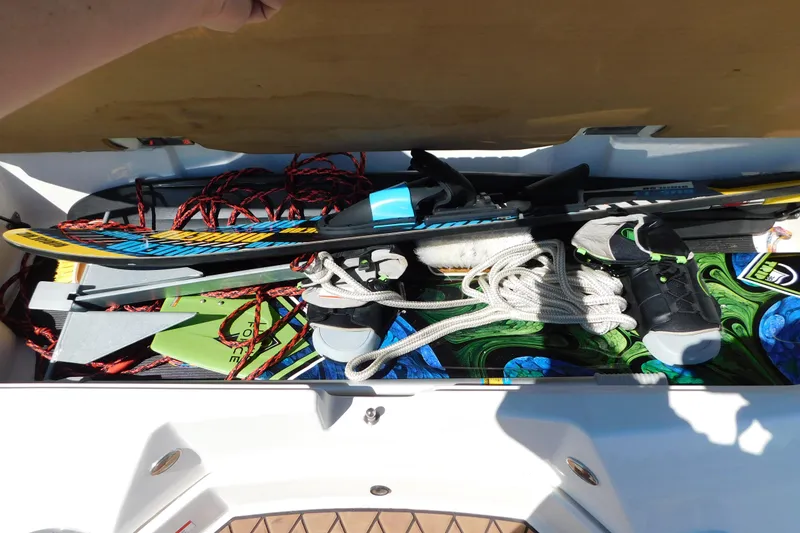 Slide: The Image of Storage compartment of 2018 Sea Ray SLX-W 230 with water sports gear and ropes. - 57