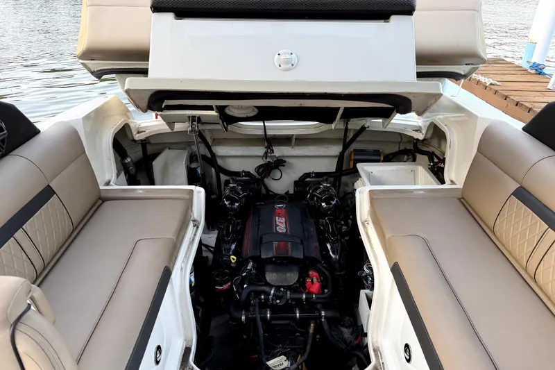 Slide: The Image of 2018 Sea Ray SLX-W 230 boat engine compartment with seating, dockside view. - 64