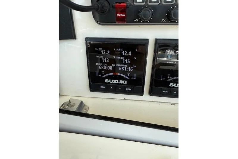 Slide: The Image of Control panel of a 1999 Venture 34 Open boat with Suzuki engine displays. - 5