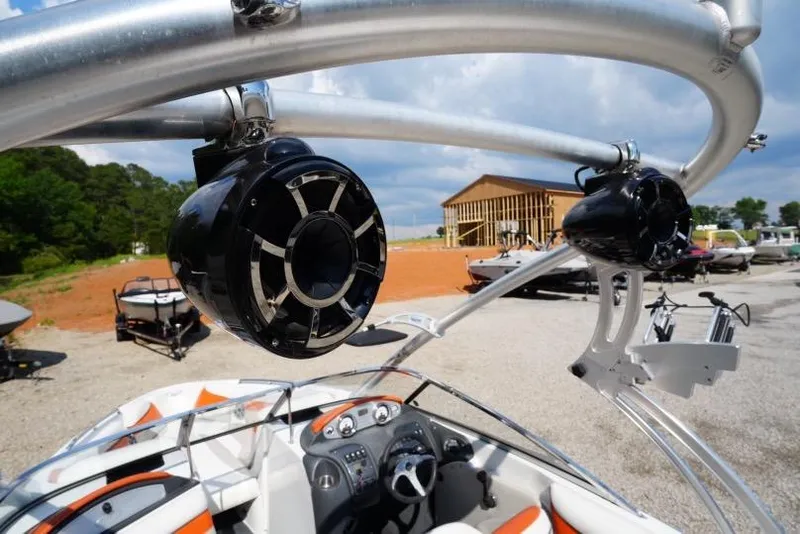 Slide: The Image of 2008 Tigé 24Ve boat with tower speakers, parked outdoors under a cloudy sky. - 12