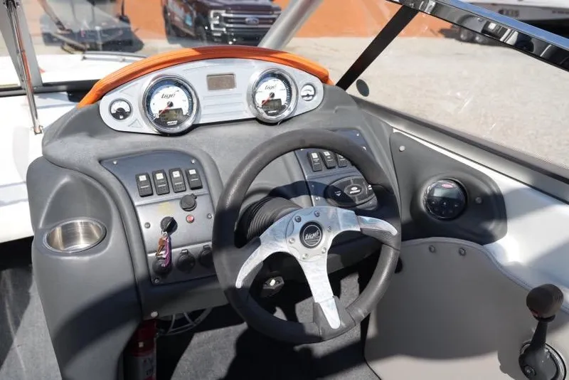 Slide: The Image of 2008 Tigé 24Ve boat dashboard with steering wheel and control panel. - 15