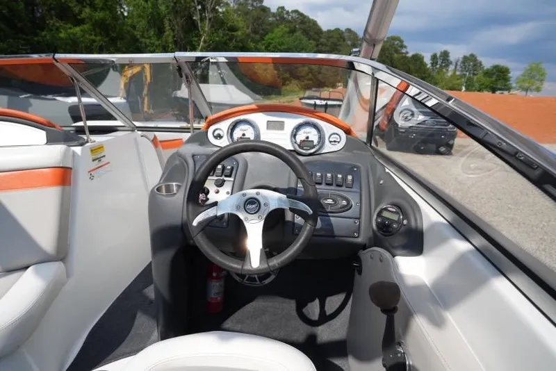 Slide: The Image of 2008 Tigé 24Ve boat dashboard with steering wheel and control panel. - 6