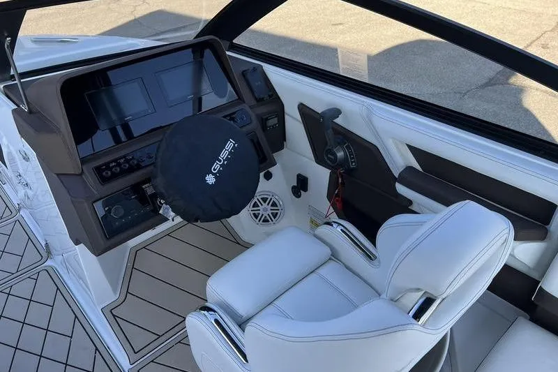 Slide: The Image of 2025 Cobalt R6 boat interior with modern dashboard and white seating. - 11
