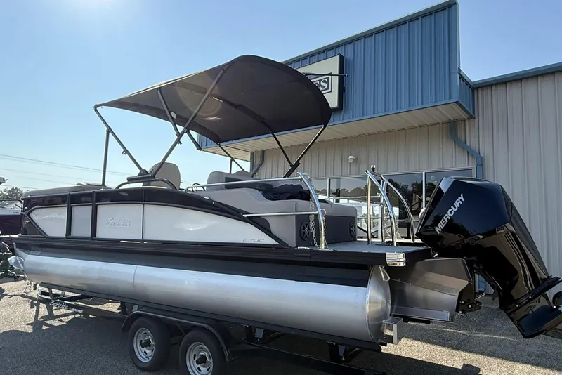 Slide: The Image of 2025 Barletta Cabrio 22UC pontoon boat with Mercury engine, displayed outdoors. - 12