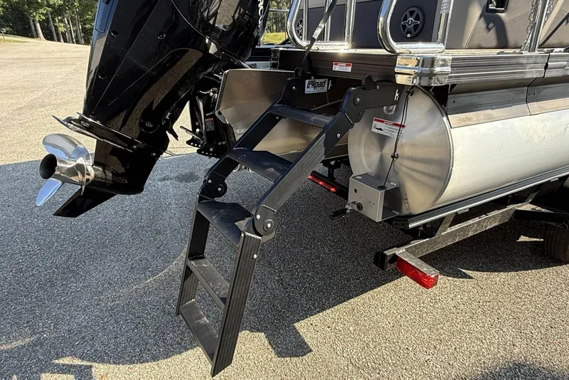 Slide: The Image of 2025 Barletta Cabrio 22UC boat with motor and foldable ladder on trailer. - 13