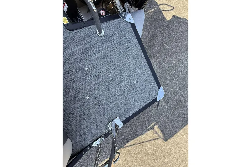 Slide: The Image of 2025 Barletta Cabrio 22UC boat deck with textured flooring and metal fixtures. - 15