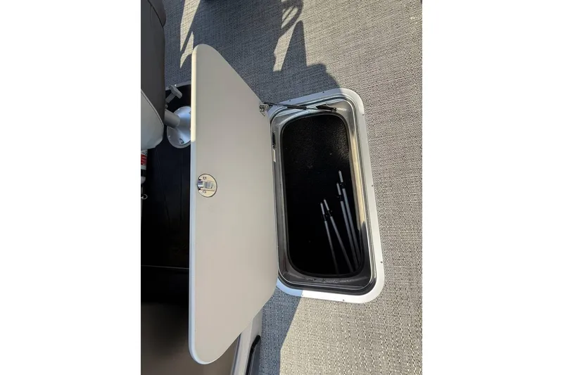 Slide: The Image of Open storage compartment in 2025 Barletta Cabrio 22UC boat, showing interior details. - 24