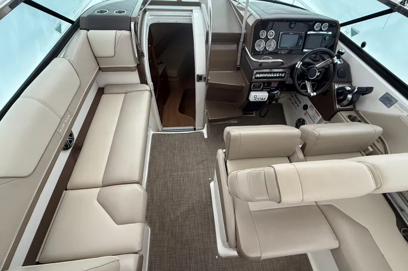 Slide: The Image of 2015 Formula 310 Sun Sport boat interior with beige seating and modern dashboard. - 11