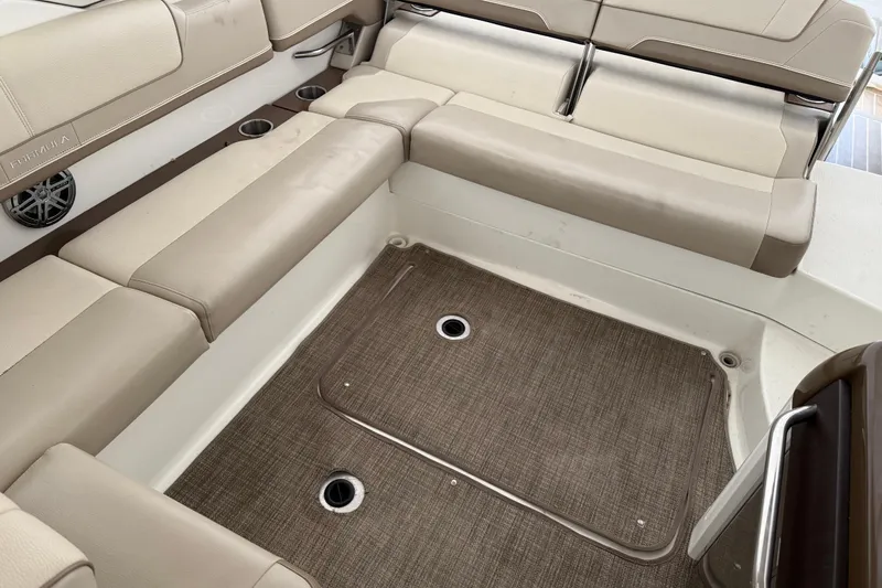 Slide: The Image of 2015 Formula 310 Sun Sport boat interior with beige seating and carpeted floor. - 14