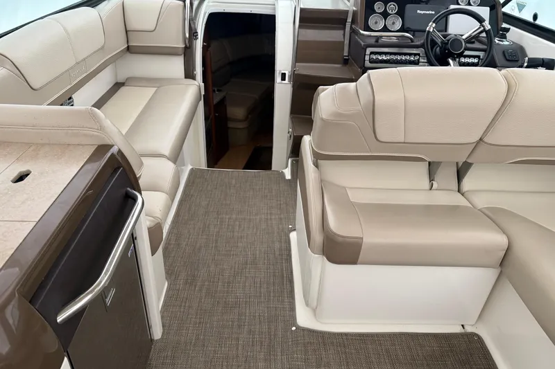 Slide: The Image of Luxurious interior of 2015 Formula 310 Sun Sport boat with beige seating and modern dashboard. - 15