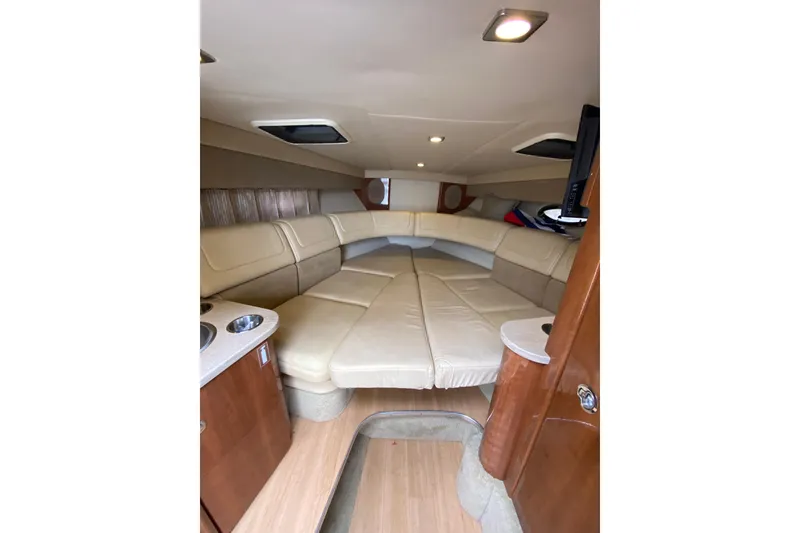 Slide: The Image of 2015 Formula 310 Sun Sport cabin interior with beige seating and wooden accents. - 16