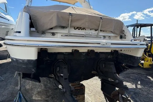 Slide: The Image of 2015 Formula 310 Sun Sport boat with covered stern, displayed outdoors. - 21