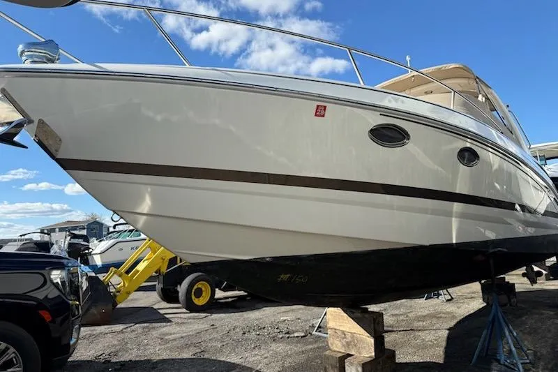 Slide: The Image of 2015 Formula 310 Sun Sport boat on dry dock under clear blue sky. - 23