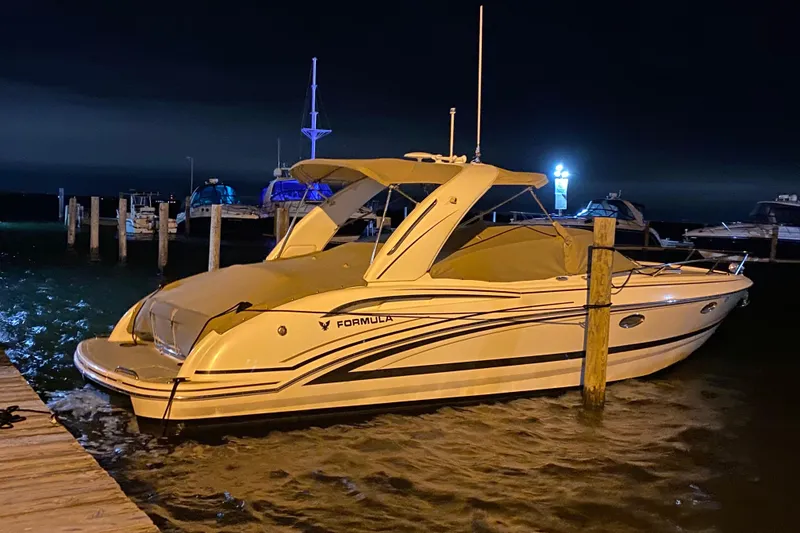 Slide: The Image of 2015 Formula 310 Sun Sport boat docked at night, illuminated by soft lighting. - 24