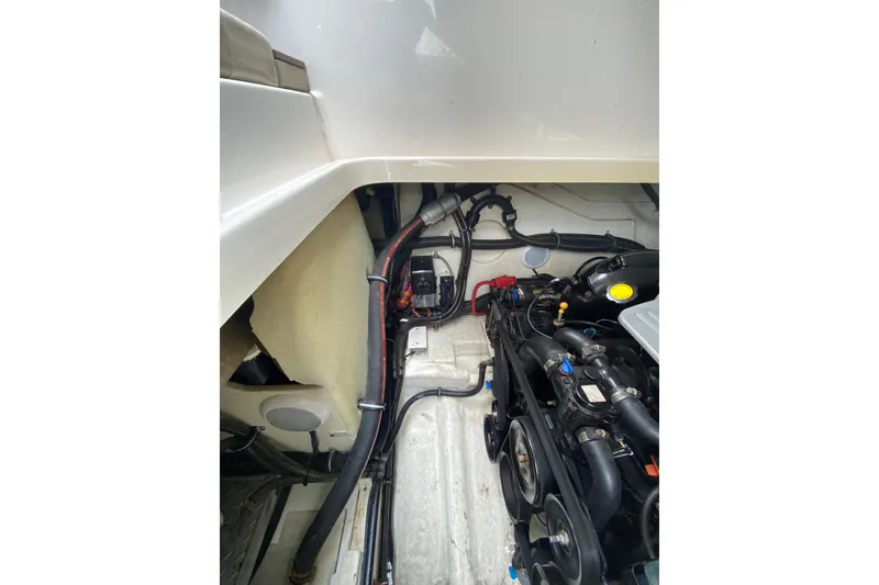 Slide: The Image of Engine compartment of a 2015 Formula 310 Sun Sport boat, showcasing mechanical components. - 27
