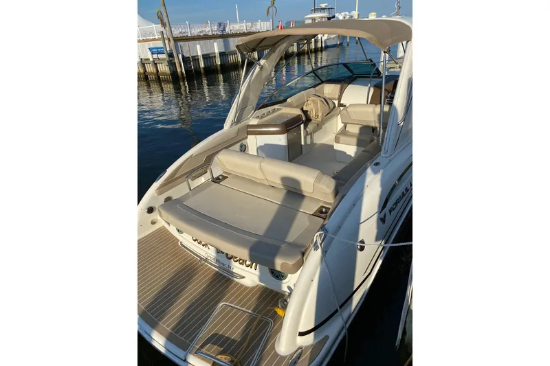 Slide: The Image of 2015 Formula 310 Sun Sport boat docked, featuring spacious seating and sleek design. - 3