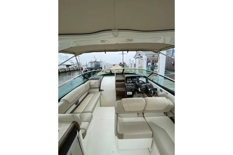 Slide: The Image of 2015 Formula 310 Sun Sport boat interior with beige seating and modern dashboard. - 5