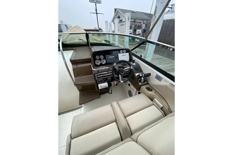 Slide: The Image of 2015 Formula 310 Sun Sport boat interior with steering wheel and control panel. - 6