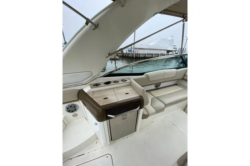 Slide: The Image of 2015 Formula 310 Sun Sport boat interior with seating and storage, dockside view. - 7