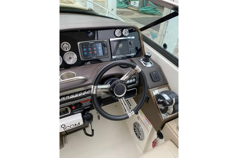 Slide: The Image of Dashboard of a 2015 Formula 310 Sun Sport boat with steering wheel and controls. - 8