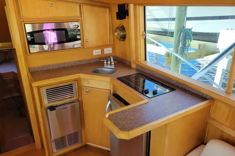 Slide: The Image of 1979 Bertram 38 Convertible yacht kitchen with microwave, stove, and sink. - 12