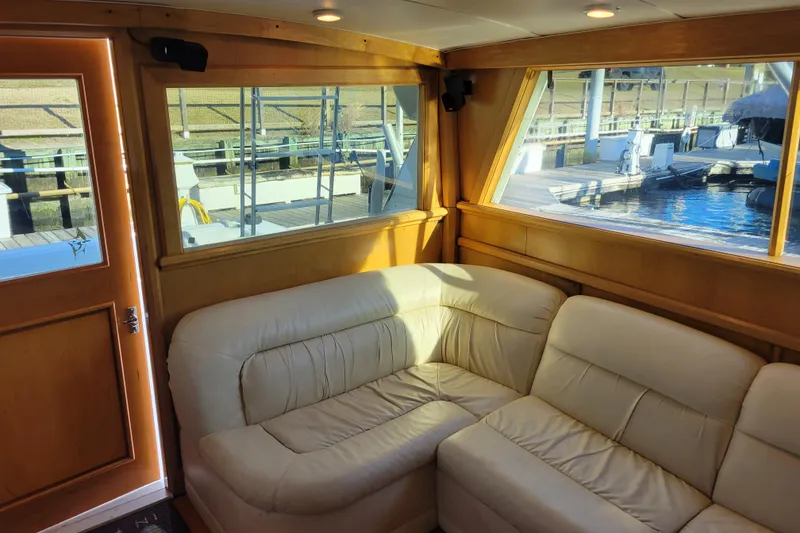 Slide: The Image of Interior of 1979 Bertram 38 Convertible yacht with cream leather seating and wooden accents. - 13