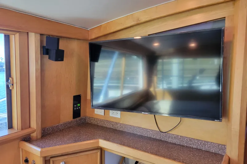Slide: The Image of Interior of 1979 Bertram 38 Convertible with mounted TV and wooden cabinetry. - 17