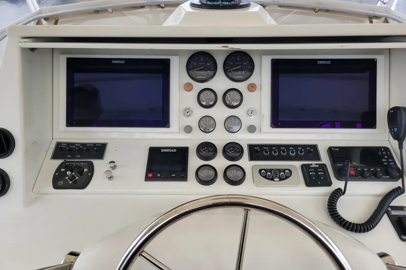 Slide: The Image of 1979 Bertram 38 Convertible helm with Simrad displays and control panels. - 20