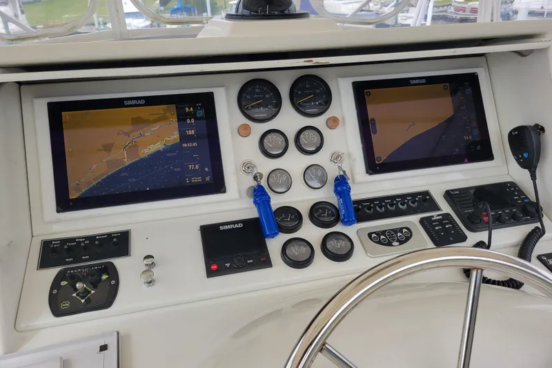 Slide: The Image of 1979 Bertram 38 Convertible boat dashboard with navigation screens and controls. - 21