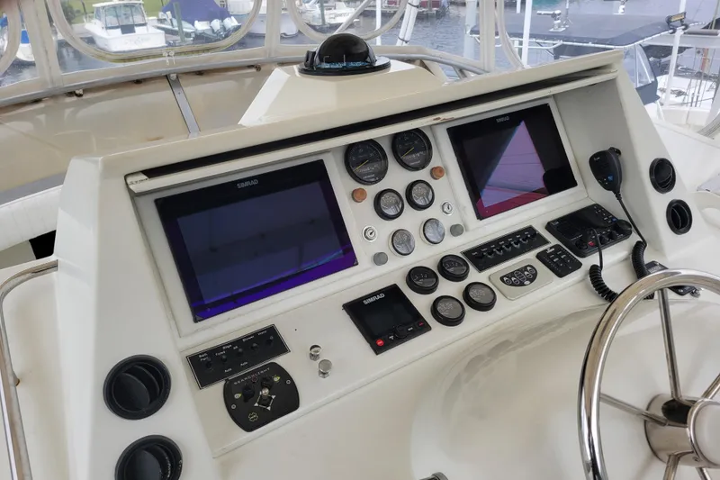 Slide: The Image of 1979 Bertram 38 Convertible yacht dashboard with navigation instruments and steering wheel. - 22