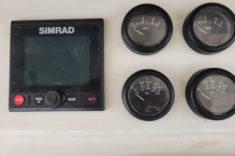 Slide: The Image of Simrad display and gauges on 1979 Bertram 38 Convertible boat dashboard. - 25