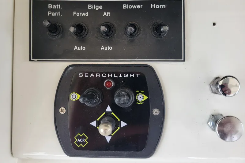 Slide: The Image of Control panel of a 1979 Bertram 38 Convertible boat with searchlight and switches. - 26