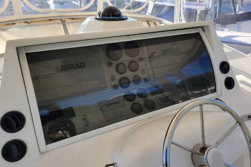 Slide: The Image of 1979 Bertram 38 Convertible helm with Simrad navigation system and steering wheel. - 31