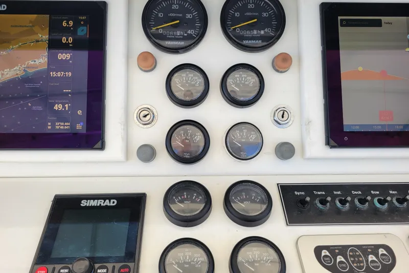 Slide: The Image of 1979 Bertram 38 Convertible dashboard with navigation screens and gauges. - 43