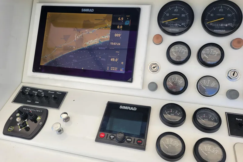 Slide: The Image of Control panel of a 1979 Bertram 38 Convertible with navigation and engine gauges. - 44