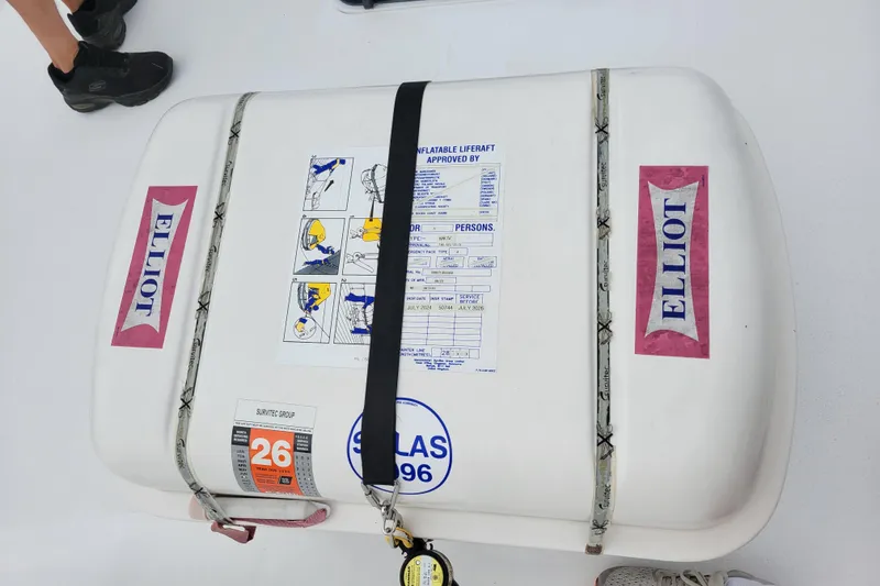 Slide: The Image of Inflatable liferaft on 1979 Bertram 38 Convertible boat, labeled "Elliot" with safety instructions. - 47
