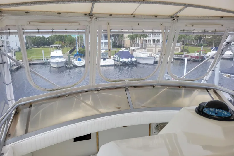 Slide: The Image of View from 1979 Bertram 38 Convertible yacht helm, overlooking marina with docked boats. - 52
