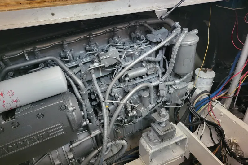 Slide: The Image of Engine compartment of a 1979 Bertram 38 Convertible boat, showcasing detailed mechanical components. - 54