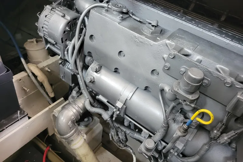 Slide: The Image of Engine compartment of a 1979 Bertram 38 Convertible boat, showcasing mechanical components. - 55