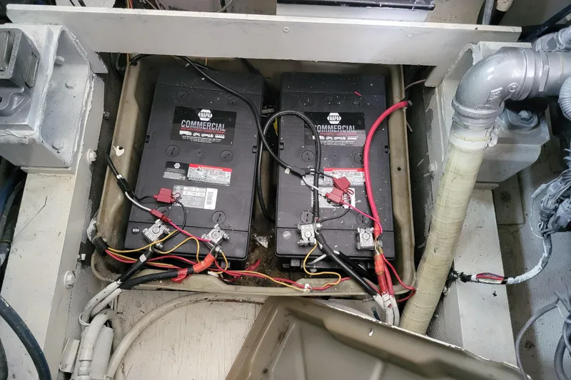 Slide: The Image of 1979 Bertram 38 Convertible boat battery compartment with wiring and connections. - 57