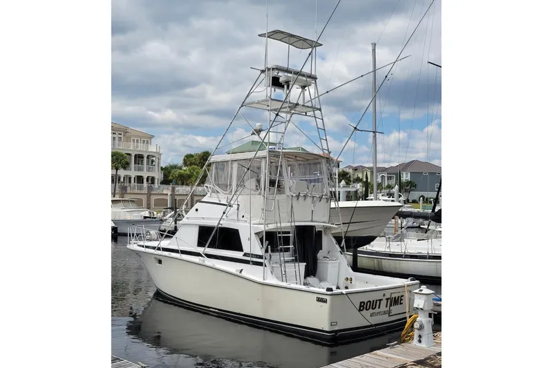 Slide: The Image of 1979 Bertram 38 Convertible yacht docked at marina under cloudy sky. - 59
