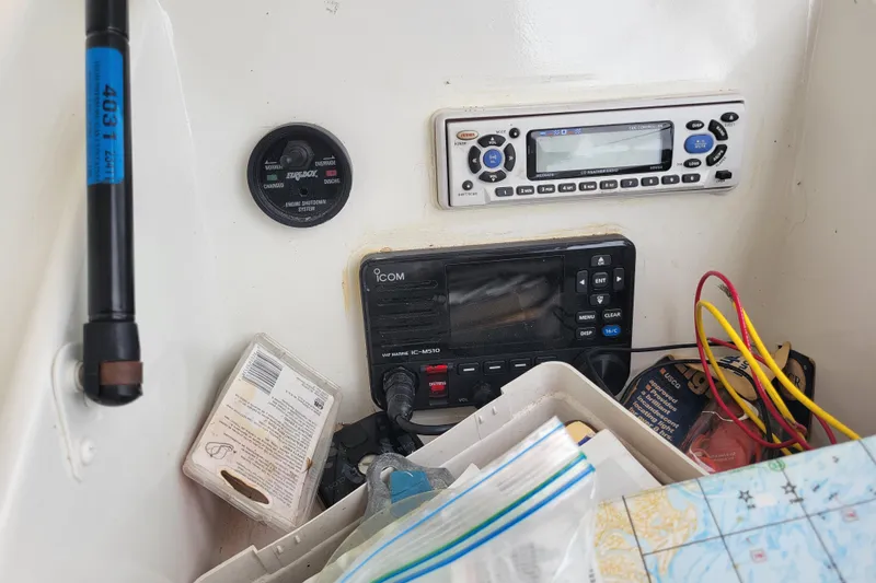 Slide: The Image of 1979 Bertram 38 Convertible boat dashboard with radio and navigation equipment. - 60