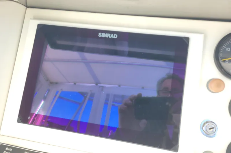 Slide: The Image of Simrad display on 1979 Bertram 38 Convertible boat dashboard with reflection. - 63