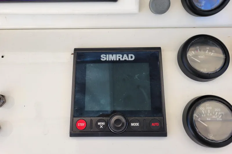 Slide: The Image of Simrad marine display and gauges on 1979 Bertram 38 Convertible boat dashboard. - 64
