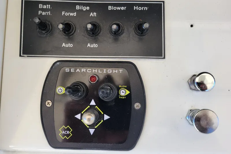 Slide: The Image of Control panel of a 1979 Bertram 38 Convertible boat with searchlight and switches. - 65